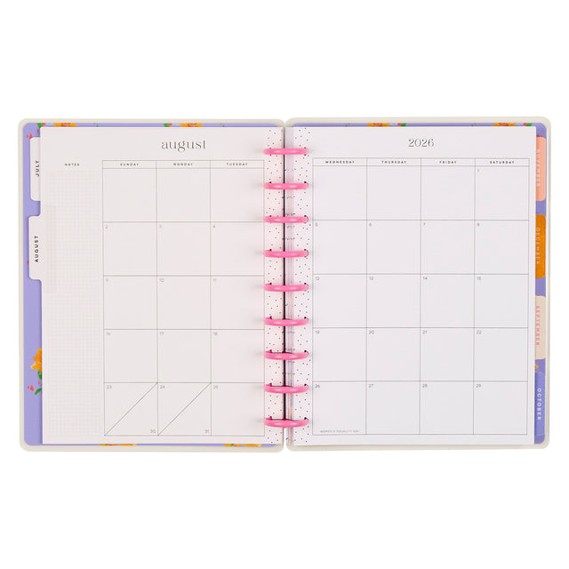 Open planner with colorful tabs on a white background