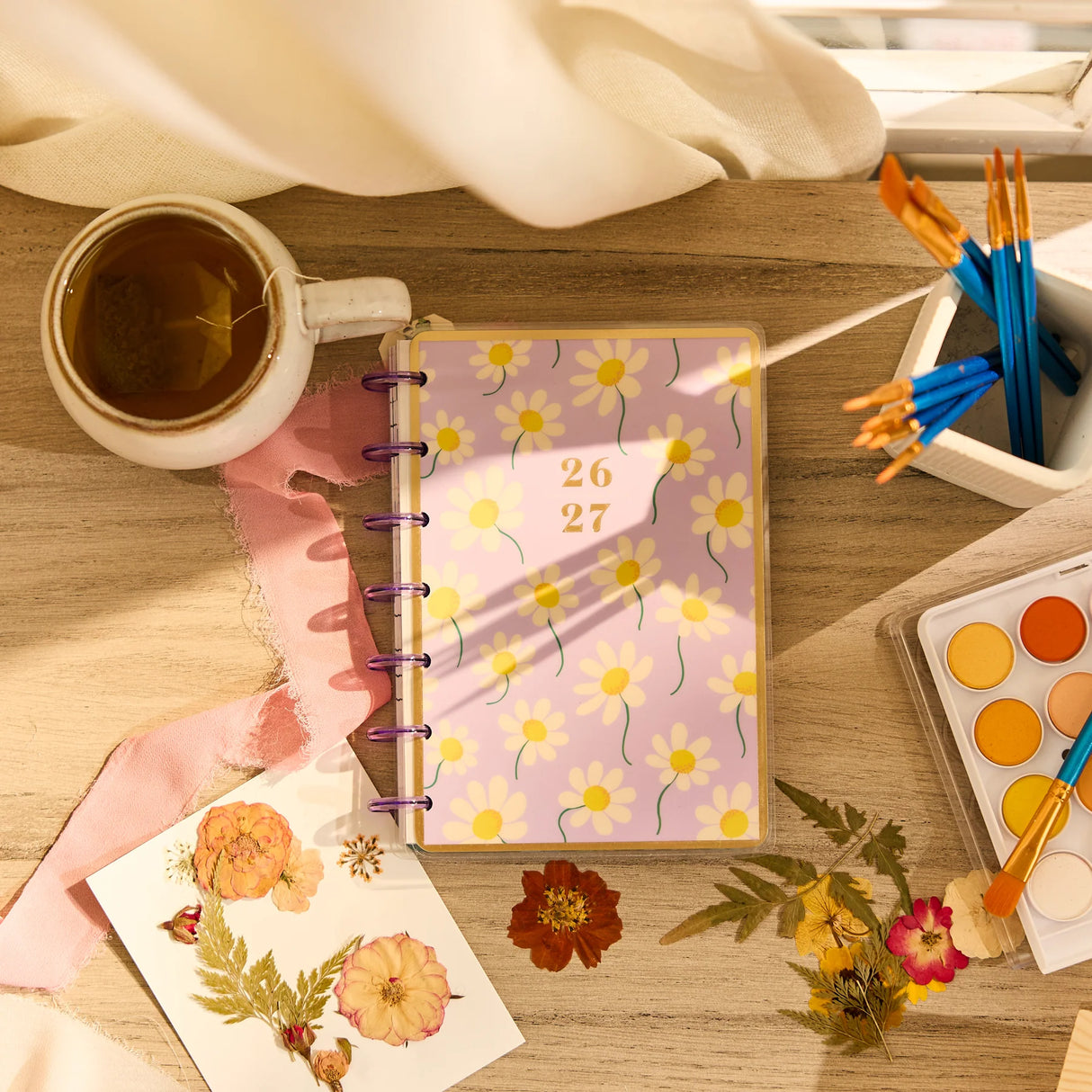 Happy Planner 2026 - 2027 Country Charm Classic Vertical 12 Month dated planner with a cup of tea and art supplies on a wooden table