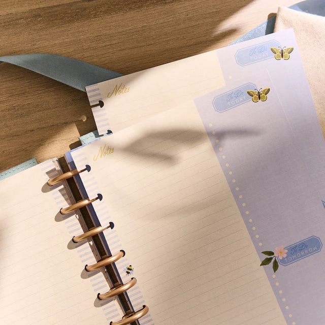 Notebook with decorative pages and a wooden surface