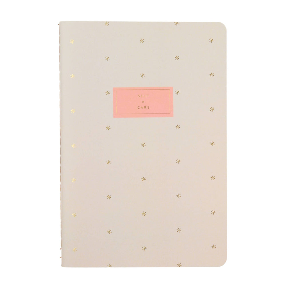 Erin Condren Self Care Journal Petite Planner - Asterisk Beige notebook with gold star patterns and a pink label on a white background
