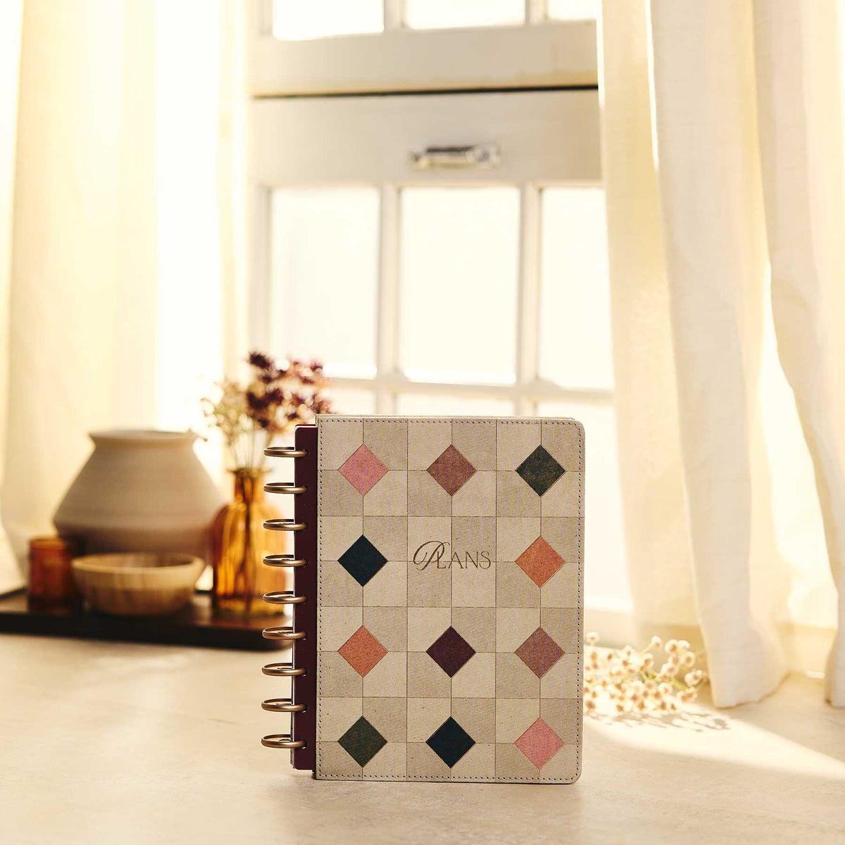 Happy Planner Amber & Oak Classic Dashboard Planner 2027 - geometric cover on a sunlit desk