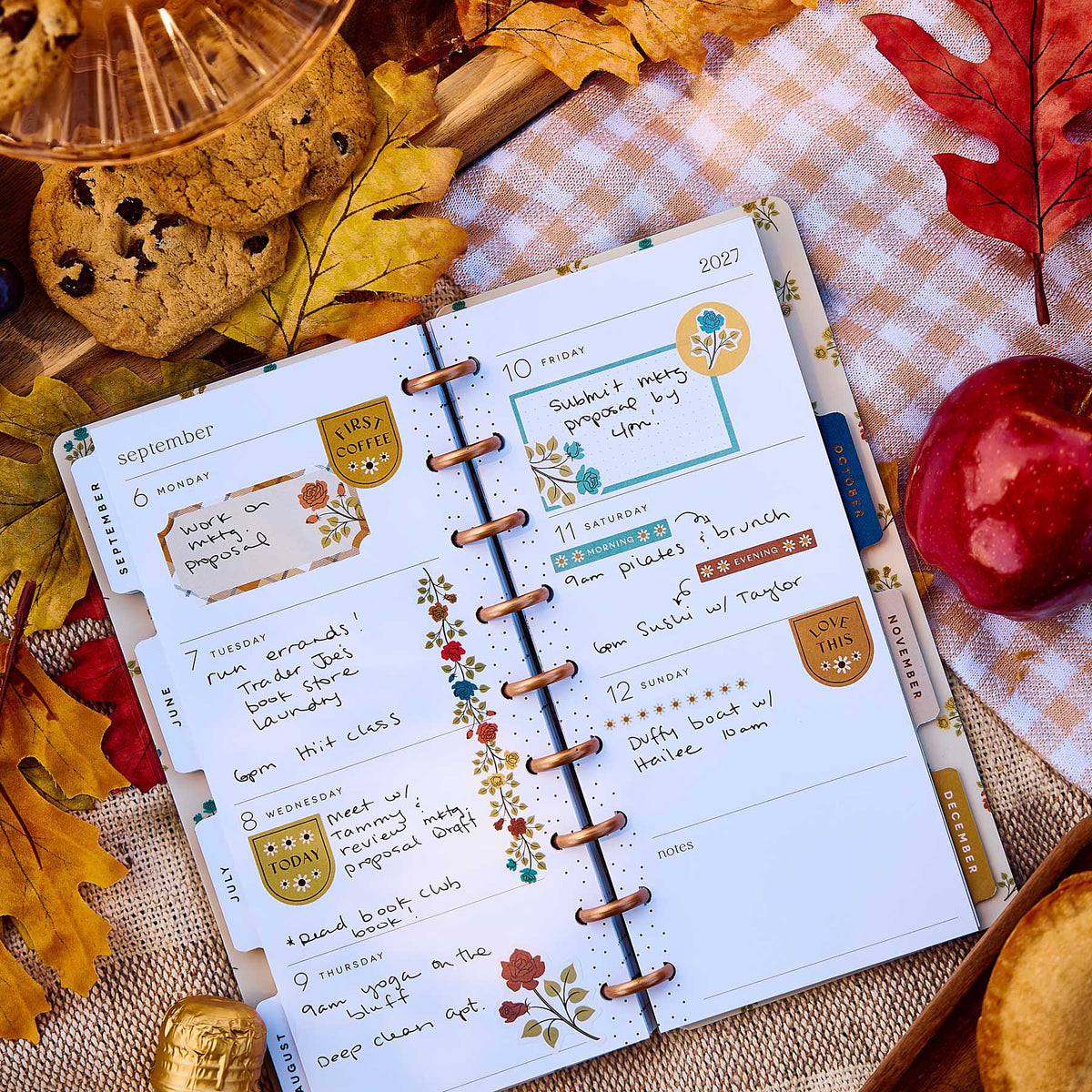 Happy Planner Fall Picnic handwritten weekly spread with floral accents beside apples and cookies