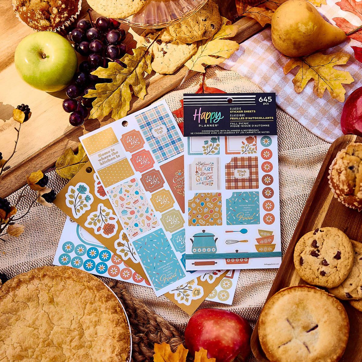 Fall Picnic Meal Planning sticker book and decorative sheets surrounded by fruit, biscuits and autumn leaves