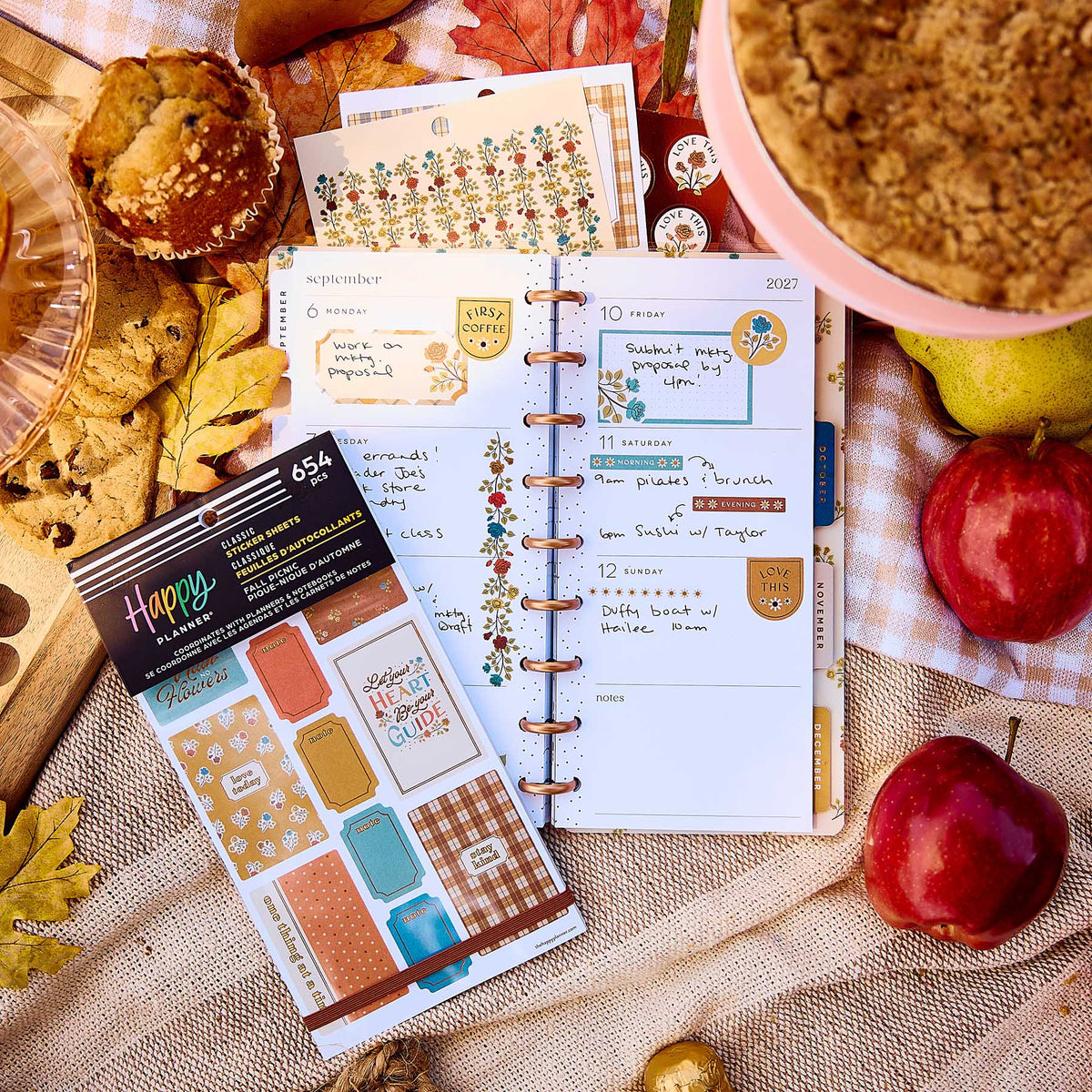 Fall Picnic sticker book beside an open decorated planner with autumn leaves, apples, cookies and pie