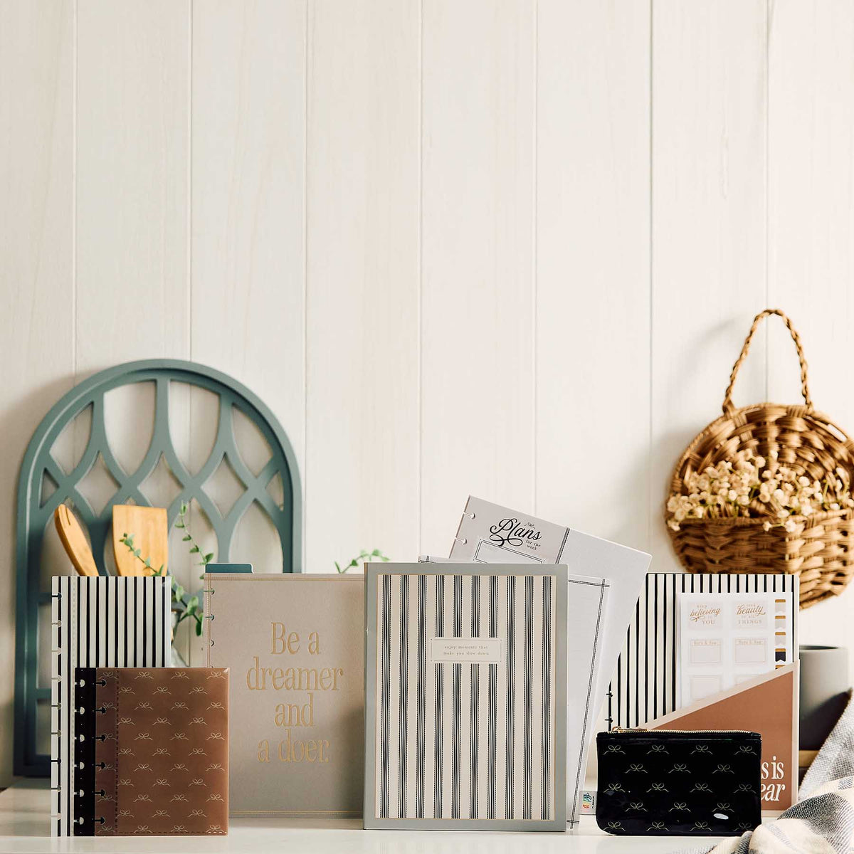 Haven & Heart companion arranged with striped notebooks and stationery on a wooden surface