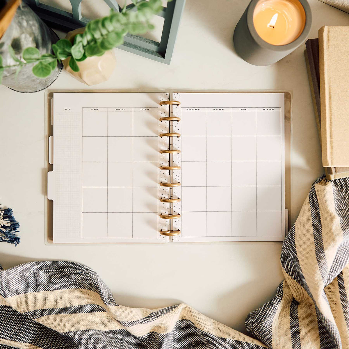 Happy Planner Haven & Heart Classic daily undated planner - blank daily spread beside a candle and blanket