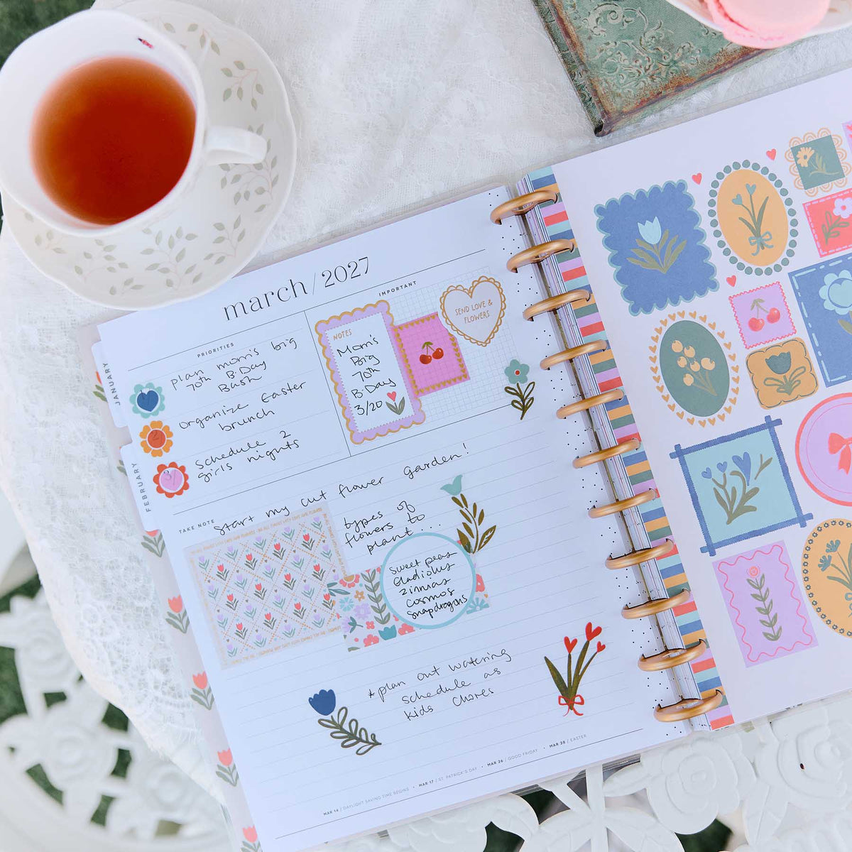 Little Garden monthly spread decorated with floral stickers and handwritten notes beside tea
