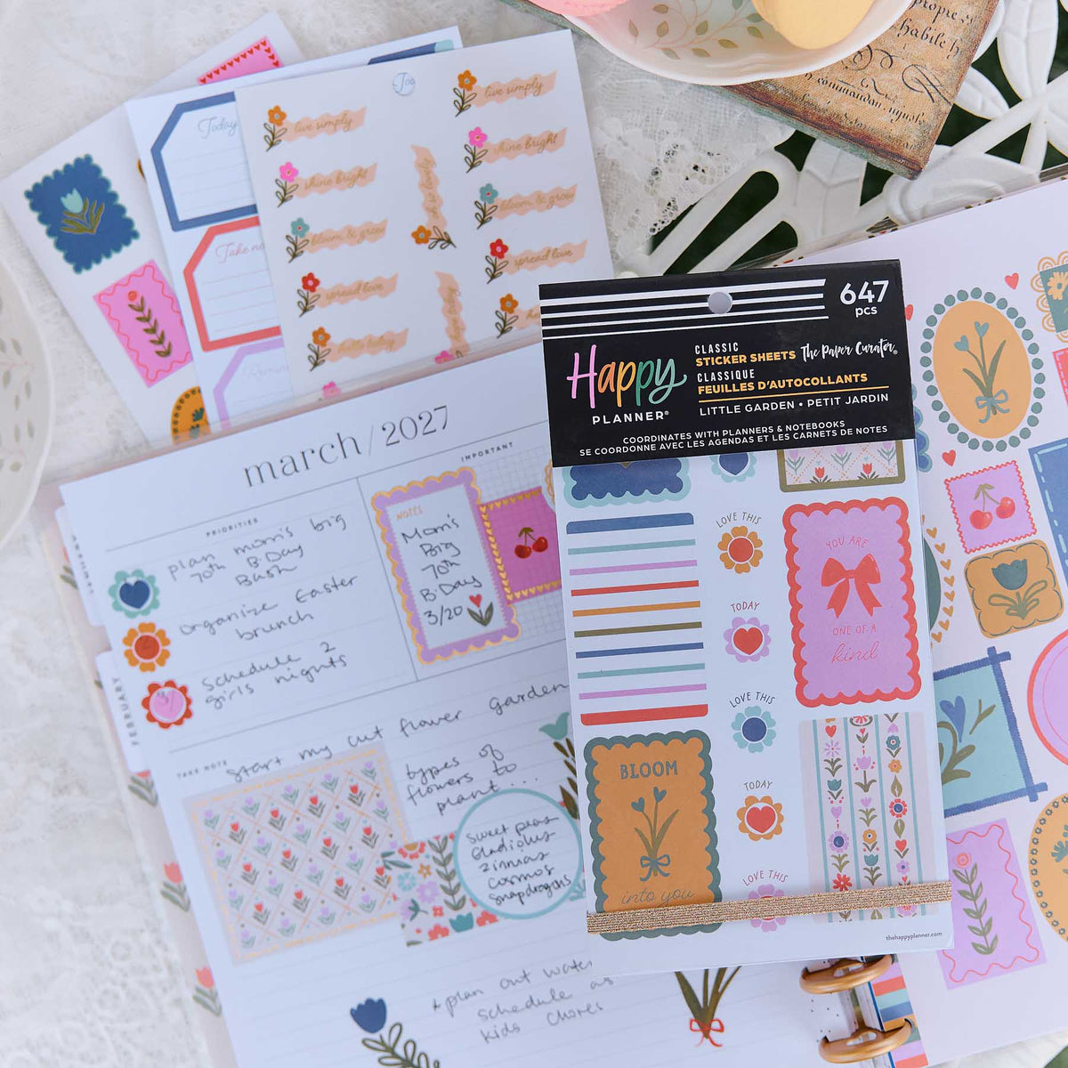 Little Garden sticker book and floral label sheets on an open March planner page