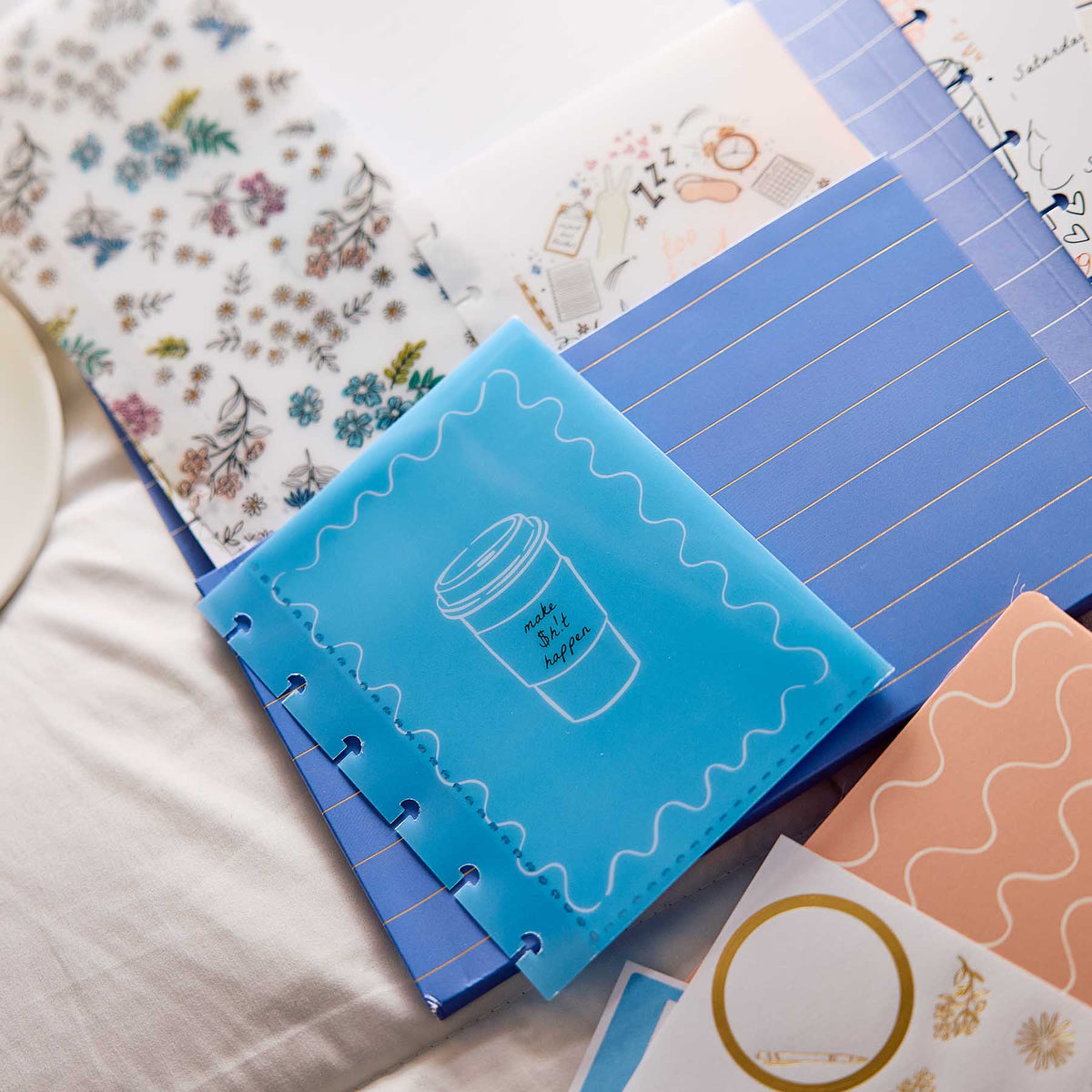 Pajama Plans discbound pages and decorative stickers on a fabric surface