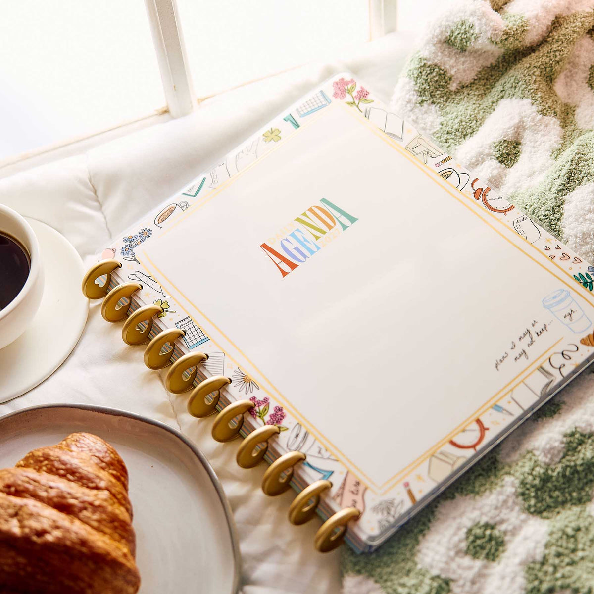 Happy Planner Pajama Plans open planner with illustrated borders beside coffee and a croissant