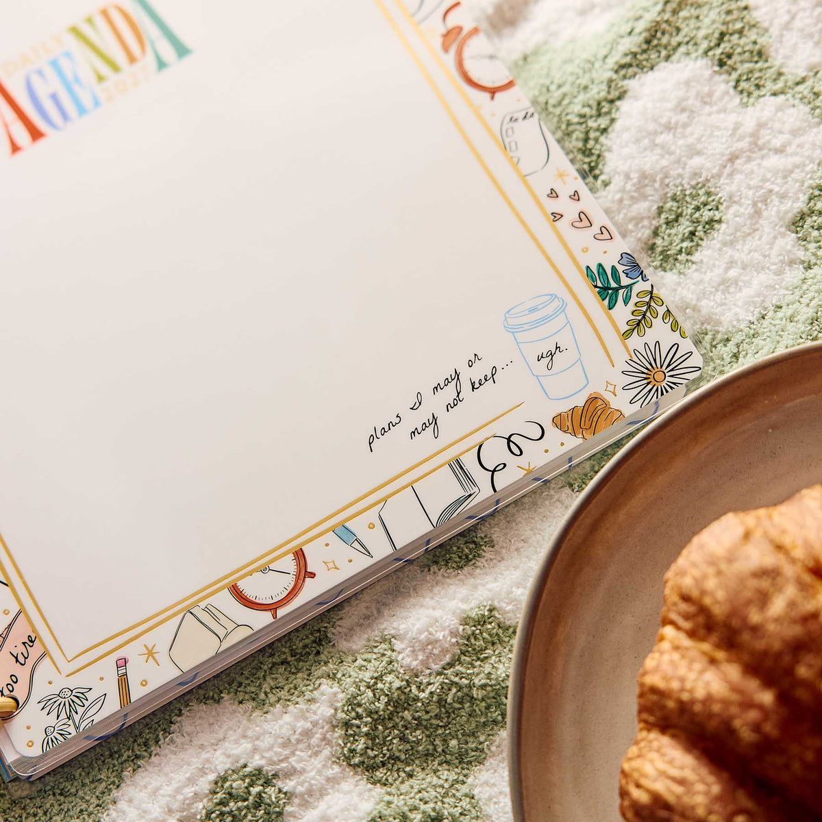 Pajama Plans Big planner with handwritten notes and floral details beside breakfast