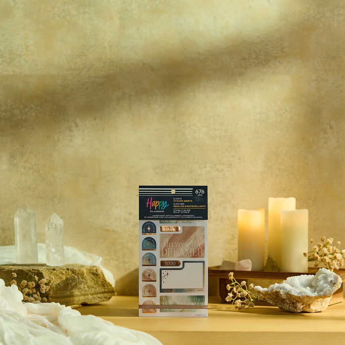 Starlit Glow sticker book displayed beside crystals and candles