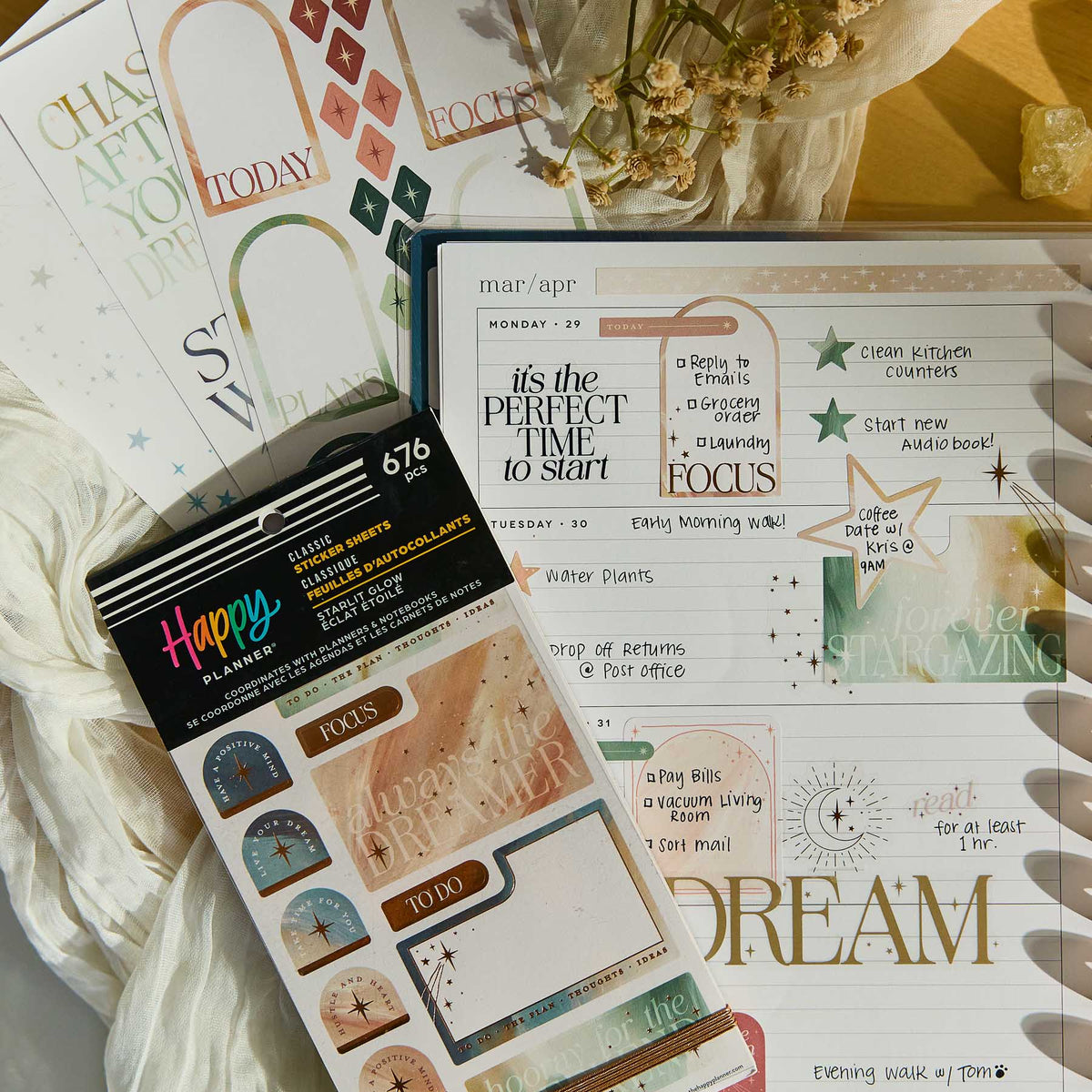 Starlit Glow decorative stickers beside a weekly planner and journalling supplies