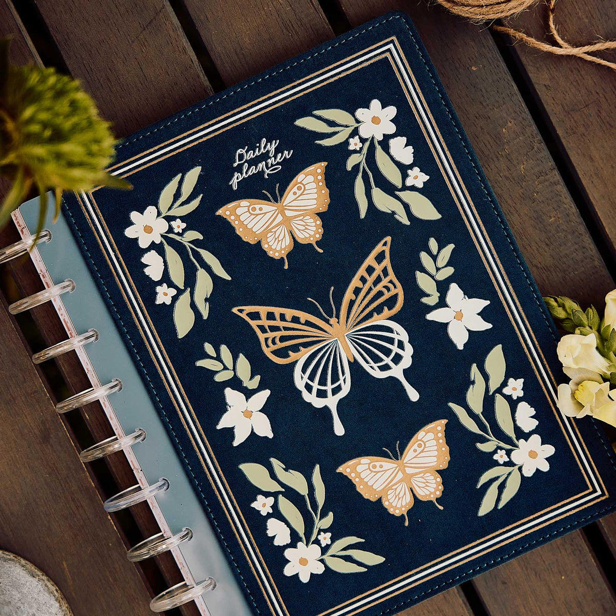 Happy Planner Wildflower Daydream Classic Dashboard Planner 2027 - navy floral butterfly cover displayed with clear discs