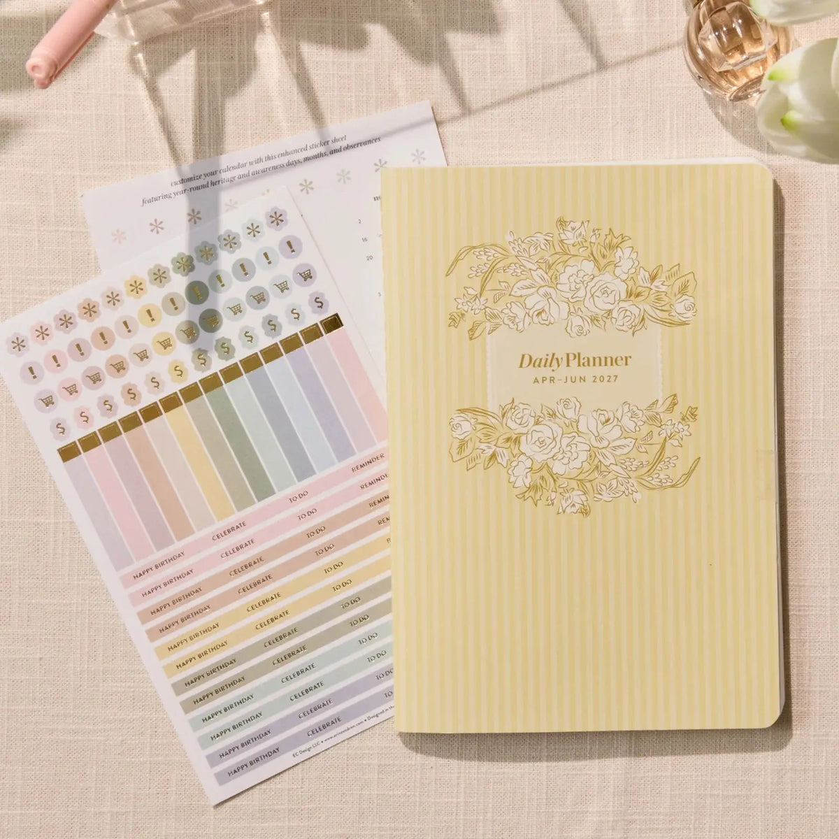Erin Condren Petite Planner: Quarterly planner cover beside included sticker sheets