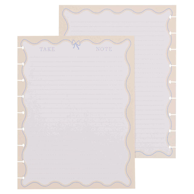 Two white notepads with decorative borders on a beige background
