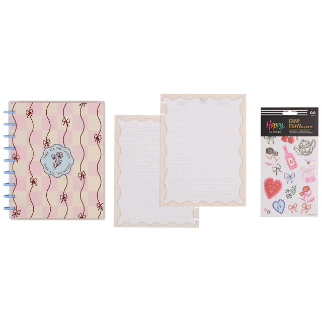 Notebook with decorative cover, plain sheet, and sticker sheet on a white background