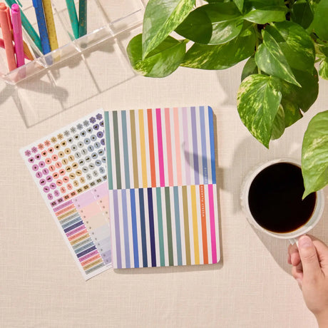Erin Condren Petite Planner: Striped planner cover beside its included sticker sheet