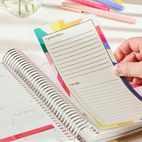 Erin Condren snap-in dashboard: Hand positioning the dashboard inside a coiled planner