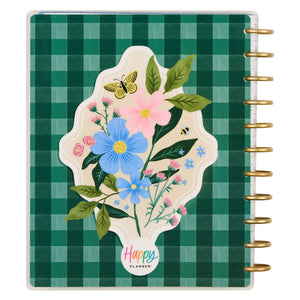 Planner with floral design and 'Happy Planner' logo on a green checkered background