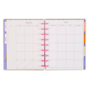 Open planner with colorful tabs on a white background