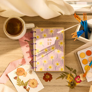 Happy Planner 2026 - 2027 Country Charm Classic Vertical 12 Month dated planner with a cup of tea and art supplies on a wooden table