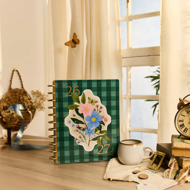 Planner with floral design on a desk near a window