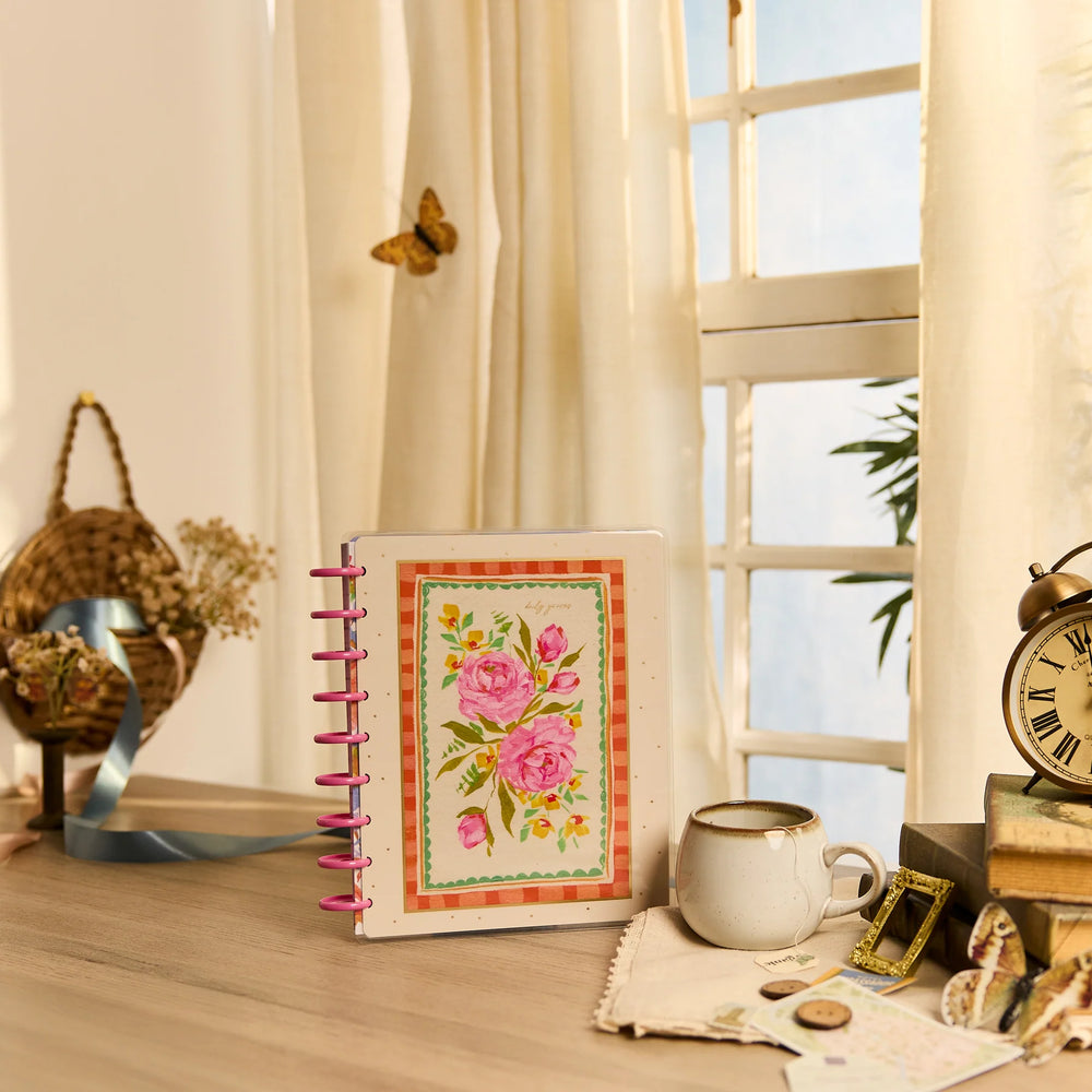 Happy Planner 2026 - 2027 French Papers Faith Classic 12 Month Dated with floral design on a desk near a window