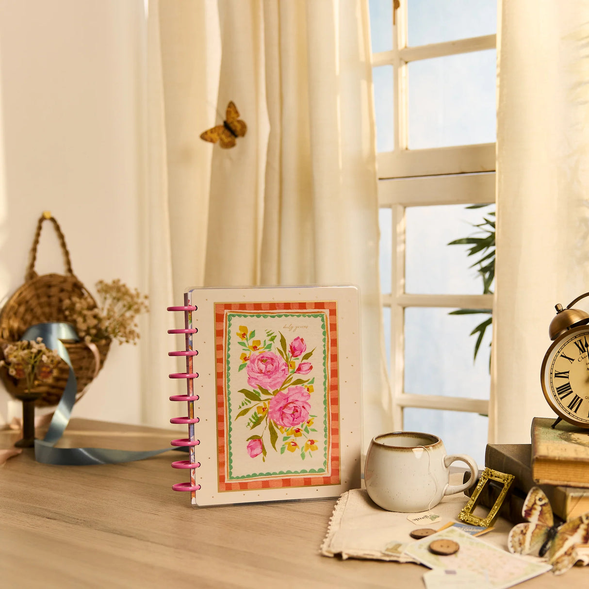 Happy Planner 2026 - 2027 French Papers Faith Classic 12 Month Dated with floral design on a desk near a window
