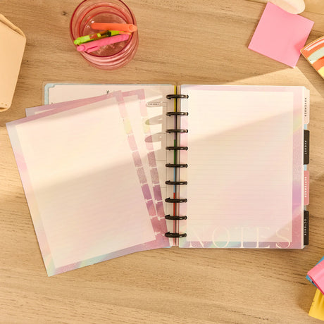 Open planner with colorful dividers on a wooden surface