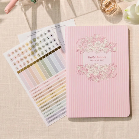 Erin Condren Petite Planner: Quarterly planner cover beside included sticker sheets