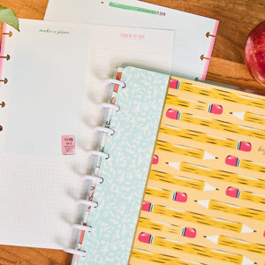notebook with stationery colourful covers on a wooden surface