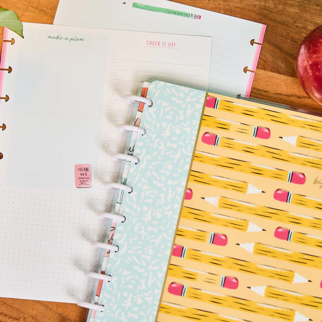 notebook with stationery colourful covers on a wooden surface