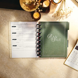 Open Amber & Oak budget journal with a review page beside a green divider and calculator