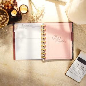Amber & Oak Budget Planner February 2027 page and save money divider beside a calculator