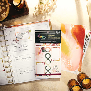 A styled flat-lay of a Happy Planner sticker set, featuring a package of abstract sticker sheets in the Classic Sugar Rush flavor, displayed next to an open spiral planner showing a decorated weekly page.