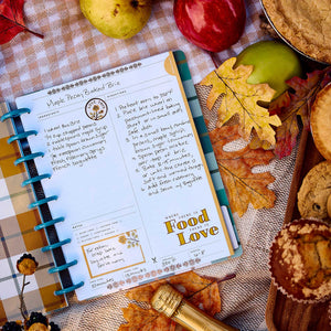Open Fall Picnic journal with handwritten recipes beside apples, leaves and cookies