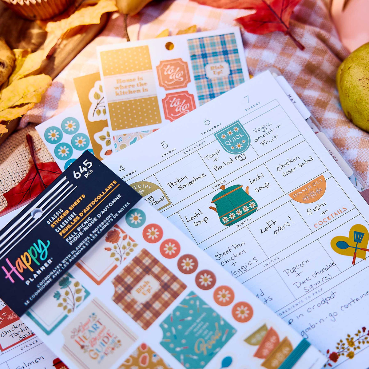 Fall Picnic Meal Planning sticker book on a handwritten weekly menu with colourful boxes and cookware designs