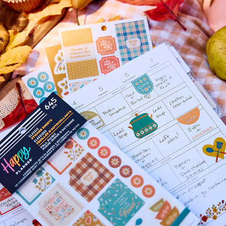 Fall Picnic Meal Planning sticker book on a handwritten weekly menu with colourful boxes and cookware designs