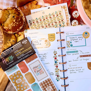 Fall Picnic sticker book and floral sheets on a weekly planner with handwritten plans beside picnic food