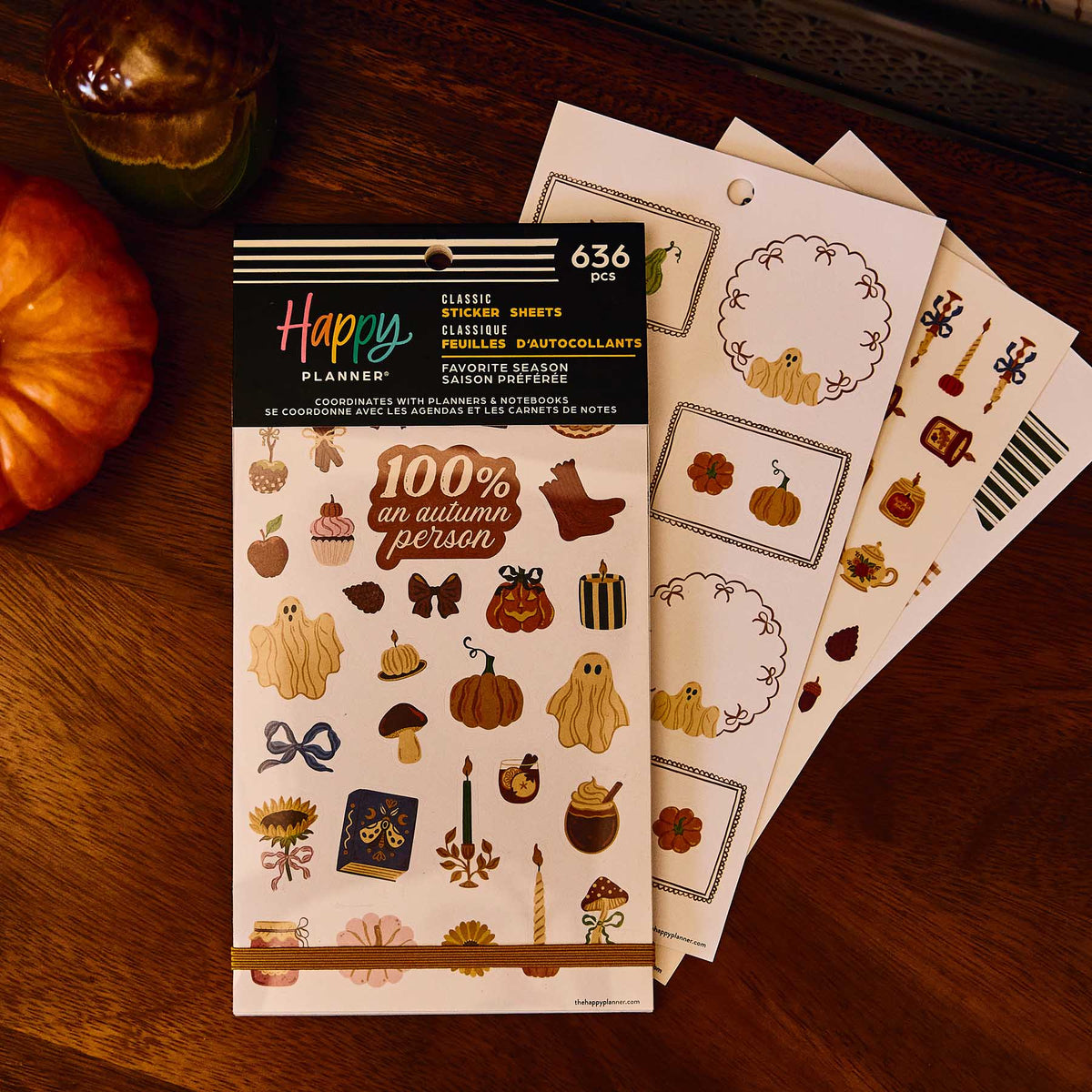 Favorite Season Classic Sticker Book beside pumpkin label sheets on a wooden table with an autumn drink