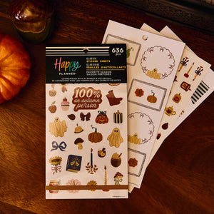 Favorite Season Classic Sticker Book beside pumpkin label sheets on a wooden table with an autumn drink