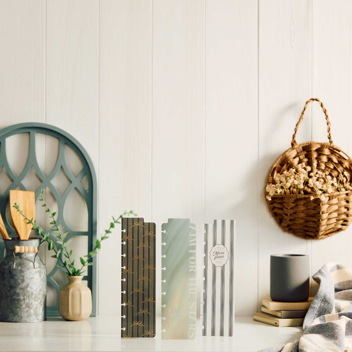 Three Happy Planner Modern Balance Classic Bookmarks standing upright on a desk beside books and a mug