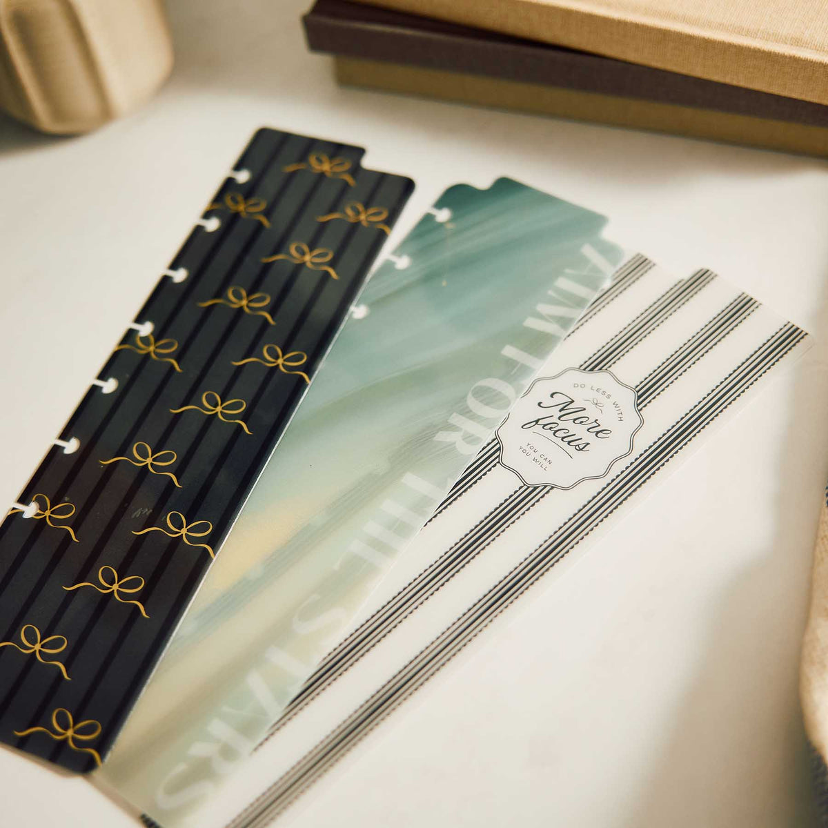 Modern Balance Classic Bookmarks arranged on a desk, showing the bow, green marbled and striped designs