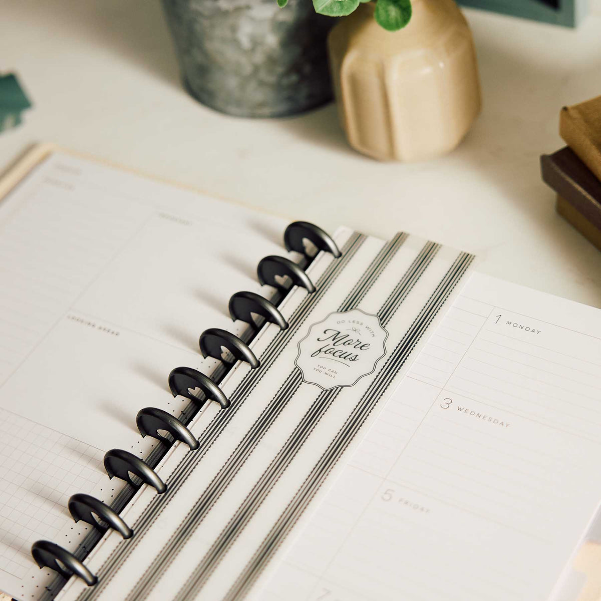 Striped Happy Planner Modern Balance bookmark marking a weekly spread in an open disc-bound planner