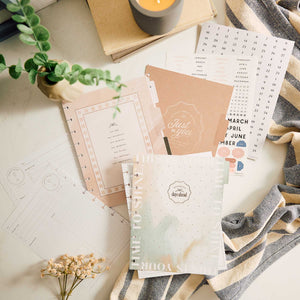 Happy Planner Modern Balance calendar inserts and guided planning pages on a desk