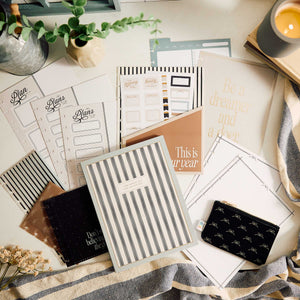 Haven & Heart accessories beside planner pages, journals, plants and a candle