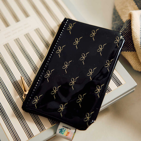 Haven & Heart black and gold patterned accessory on a striped notebook