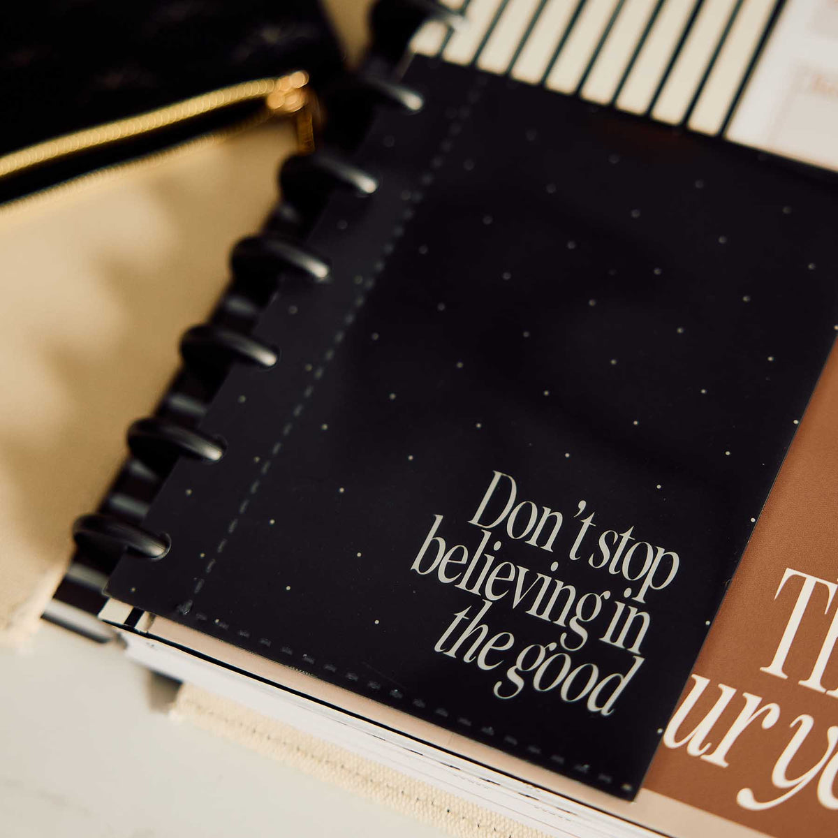 Haven & Heart planner with gold dotted cover beside a notebook and pencil case