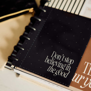 Haven & Heart planner with gold dotted cover beside a notebook and pencil case